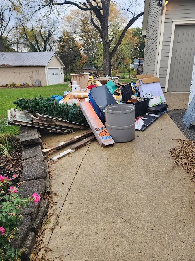 Dumpster being loaded with debris for Estate Cleanout Dumpster Rental in Farmerville